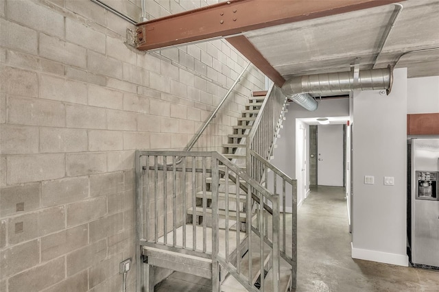 stairway with concrete flooring