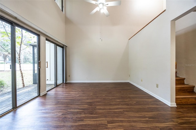 unfurnished room featuring dark wood-type flooring and ceiling fan