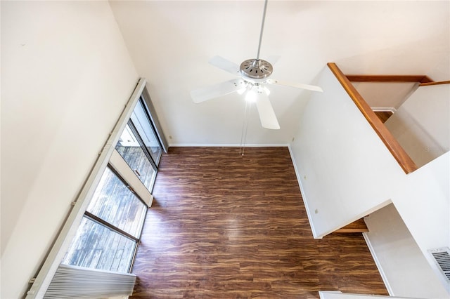 unfurnished living room with ceiling fan and dark hardwood / wood-style floors