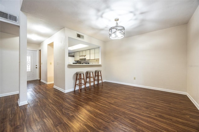 interior space with an inviting chandelier and dark hardwood / wood-style floors