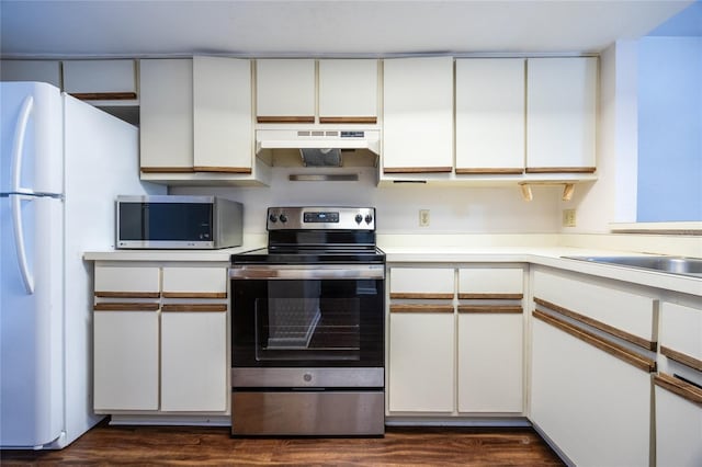 kitchen with dark hardwood / wood-style flooring, white cabinets, and appliances with stainless steel finishes