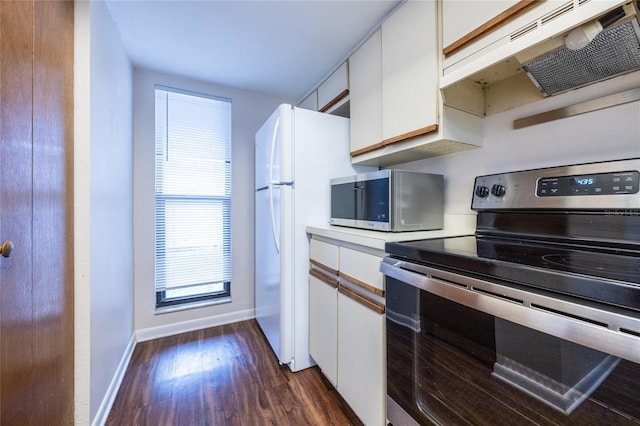 kitchen with stainless steel appliances, white cabinets, and dark hardwood / wood-style floors