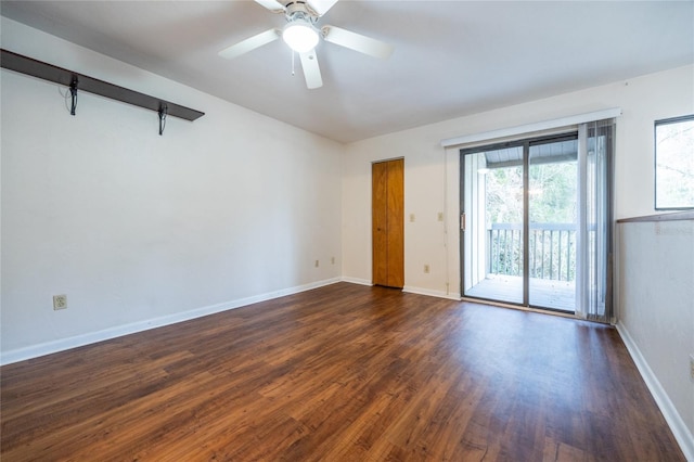 empty room featuring dark hardwood / wood-style flooring and ceiling fan