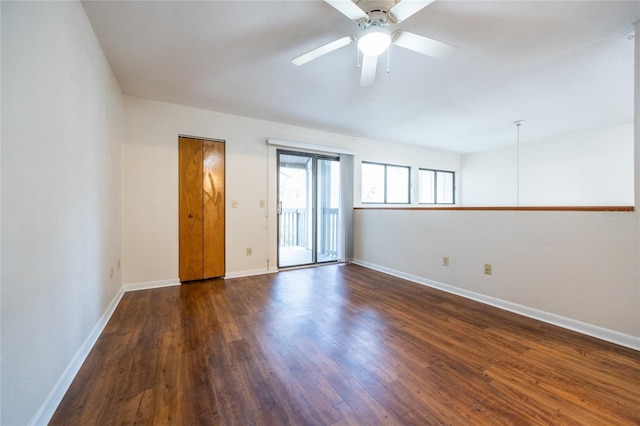 spare room with ceiling fan and dark hardwood / wood-style floors