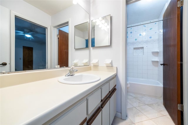 full bathroom featuring toilet, tile patterned flooring, tiled shower / bath, and vanity