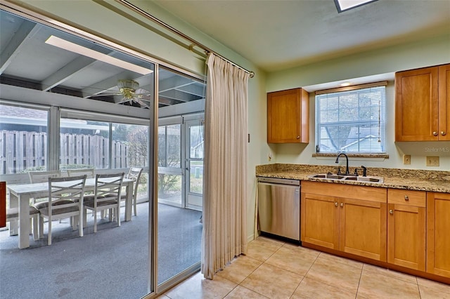 kitchen featuring sink, stainless steel dishwasher, ceiling fan, light stone countertops, and light colored carpet