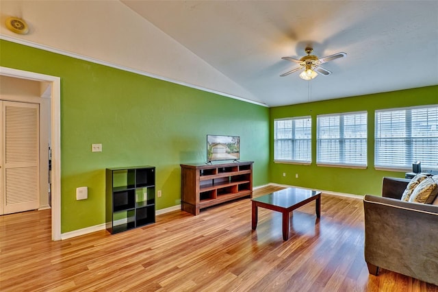 living room with ceiling fan, light hardwood / wood-style floors, plenty of natural light, and lofted ceiling