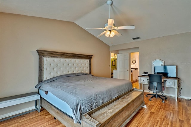 bedroom featuring connected bathroom, light hardwood / wood-style floors, vaulted ceiling, and ceiling fan