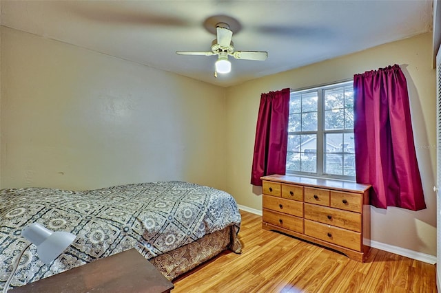 bedroom with ceiling fan and hardwood / wood-style flooring