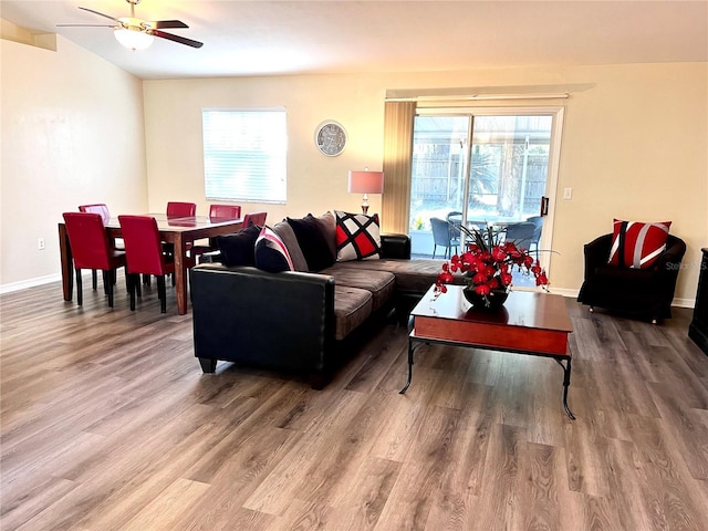 living room featuring ceiling fan and hardwood / wood-style floors