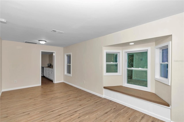 spare room with light hardwood / wood-style flooring