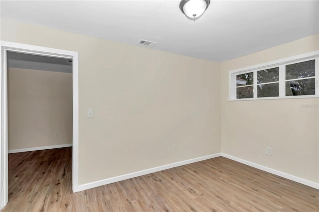 empty room with hardwood / wood-style flooring