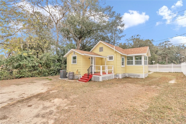 view of front of home featuring a front lawn and central air condition unit