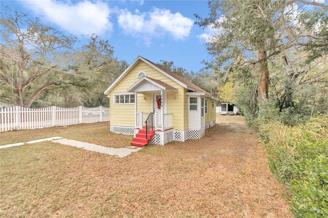 bungalow-style home featuring a front lawn