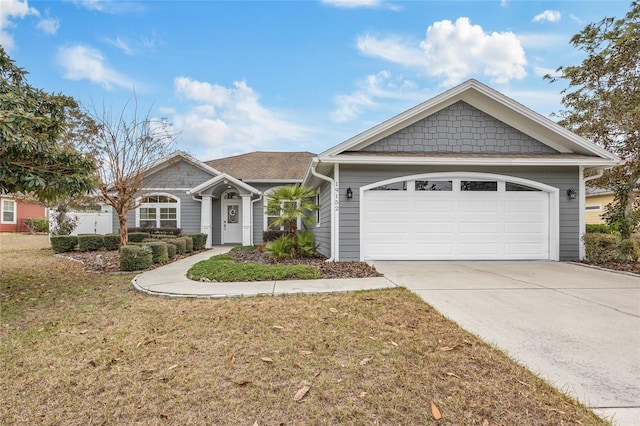 view of front of property with driveway, a garage, and a front lawn