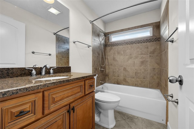 full bathroom with toilet, tiled shower / bath, tile patterned floors, and vanity