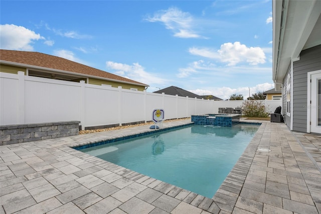 view of pool with a patio and an in ground hot tub