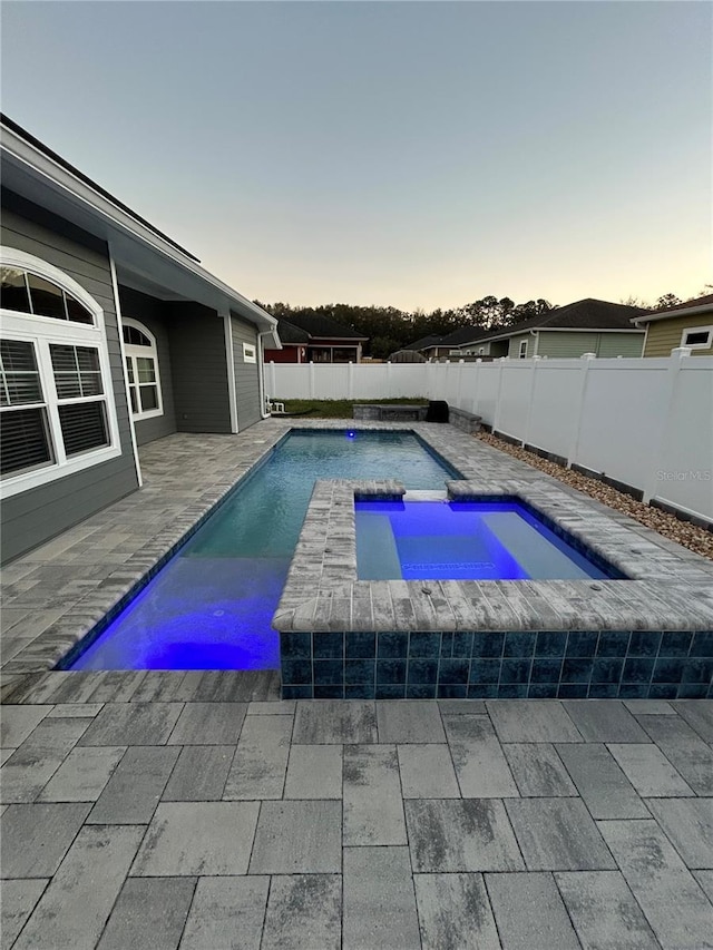 view of pool with a patio, a fenced backyard, a fenced in pool, and an in ground hot tub