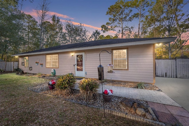 ranch-style house featuring a yard