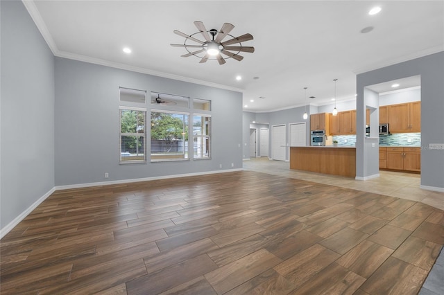 unfurnished living room featuring crown molding