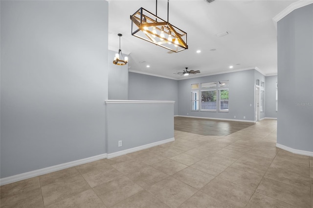 tiled empty room with ceiling fan with notable chandelier and ornamental molding