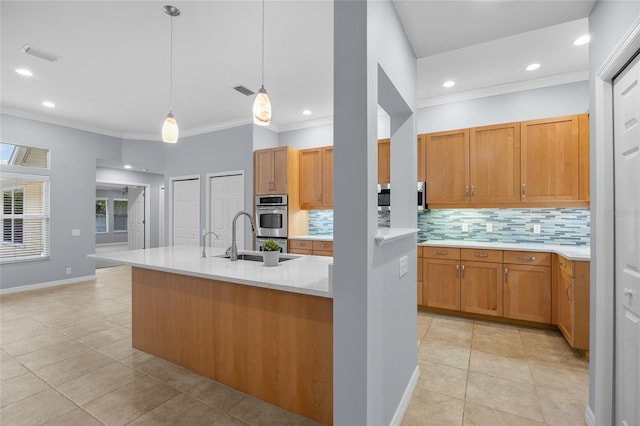 kitchen featuring hanging light fixtures, stainless steel oven, crown molding, sink, and backsplash