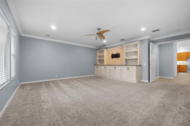 unfurnished living room featuring light colored carpet, ceiling fan, and crown molding