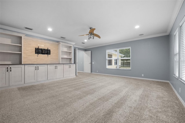 unfurnished living room with carpet floors, a wealth of natural light, and crown molding