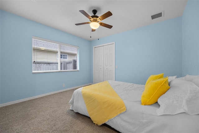 carpeted bedroom featuring ceiling fan and a closet