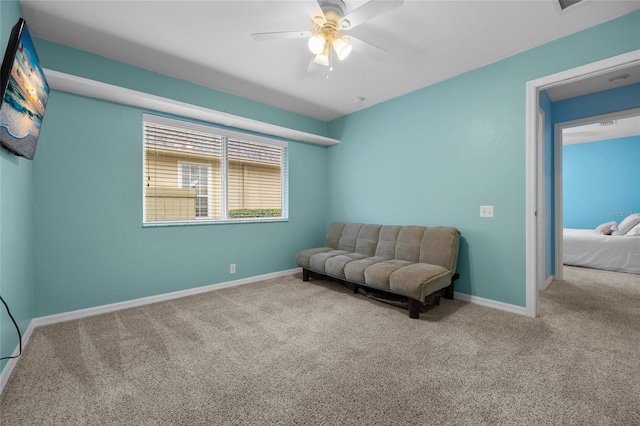 living area featuring ceiling fan and light carpet