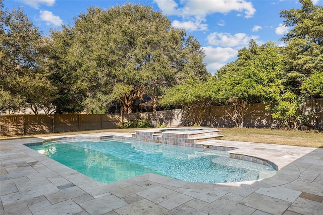 view of pool with a patio and an in ground hot tub