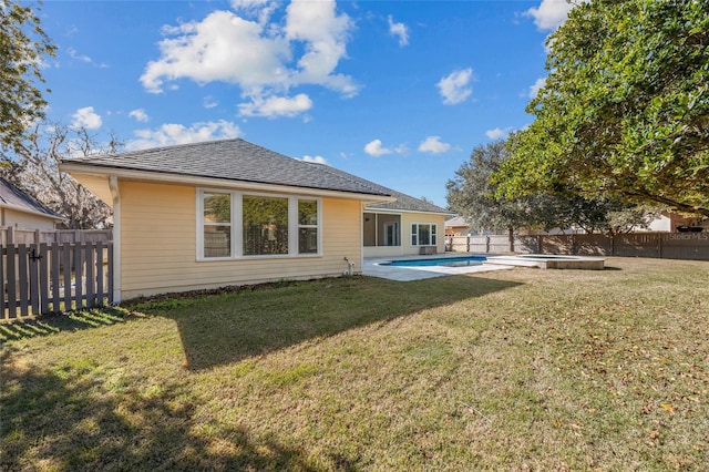 back of house with a patio, a lawn, and a fenced in pool