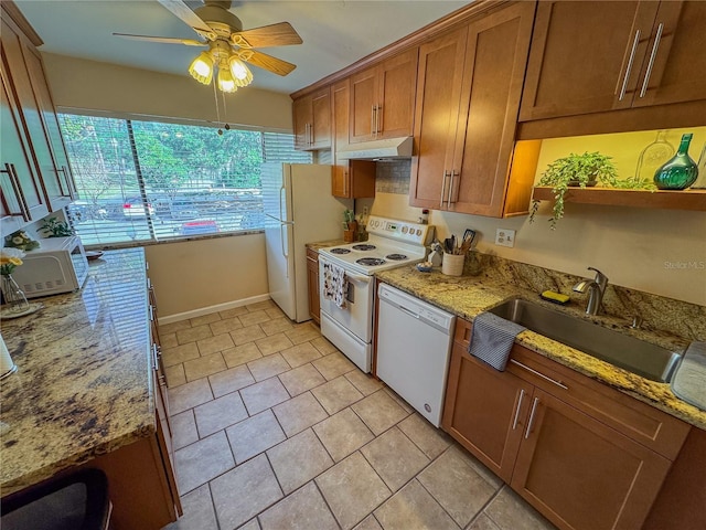 kitchen with ceiling fan, sink, white appliances, light tile patterned floors, and light stone counters