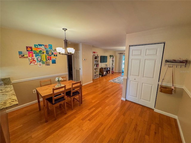 dining room featuring a chandelier and light hardwood / wood-style flooring