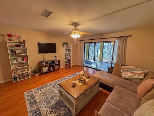 living room with ceiling fan and hardwood / wood-style flooring