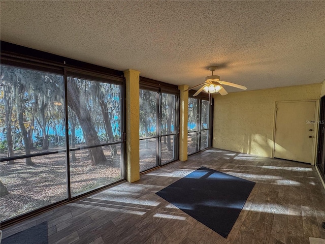 interior space with ceiling fan