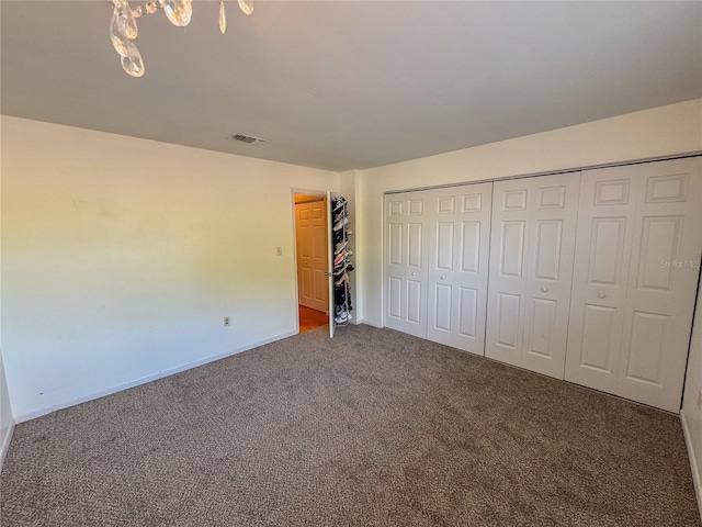 unfurnished bedroom featuring carpet and a closet