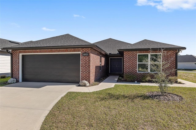 view of front of home featuring brick siding, roof with shingles, concrete driveway, a garage, and a front lawn