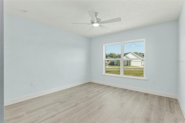 unfurnished room featuring light wood-style floors, baseboards, and a ceiling fan