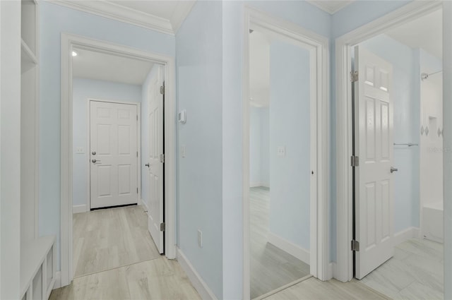 corridor with baseboards and ornamental molding