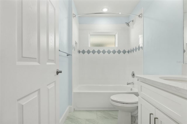 full bath featuring marble finish floor, shower / bath combination, vanity, and toilet