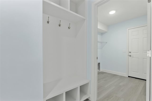 mudroom with light wood-style flooring and baseboards