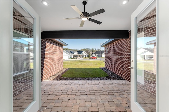 view of patio featuring a ceiling fan and a residential view