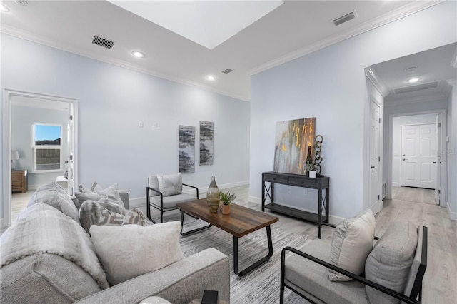 living area featuring ornamental molding, visible vents, light wood-style flooring, and baseboards