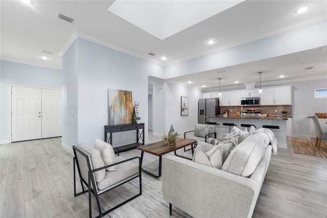 living room featuring baseboards, visible vents, and light wood-style floors