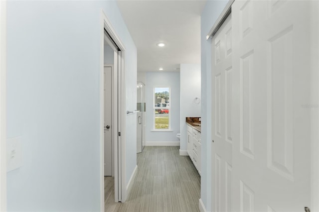 corridor with recessed lighting and baseboards