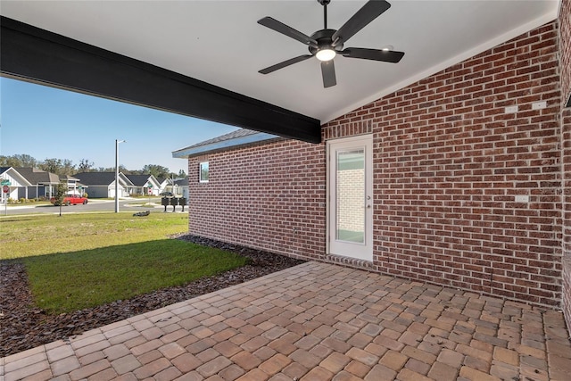 view of patio with a residential view and a ceiling fan