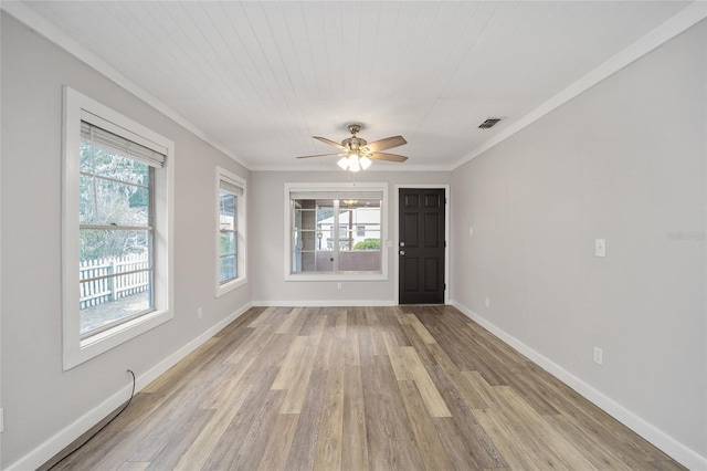 unfurnished room featuring a healthy amount of sunlight, ceiling fan, light hardwood / wood-style flooring, and ornamental molding