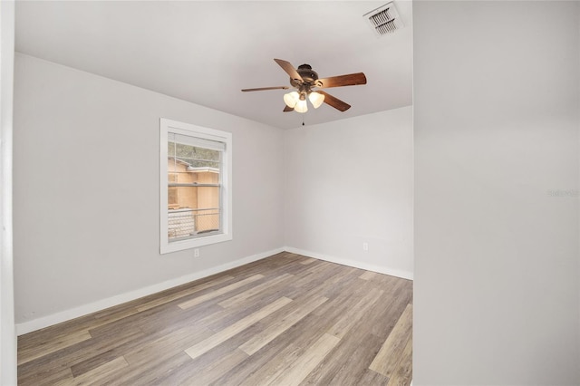 spare room featuring ceiling fan and light hardwood / wood-style floors