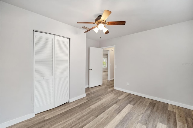 unfurnished bedroom featuring a closet, ceiling fan, and light hardwood / wood-style flooring